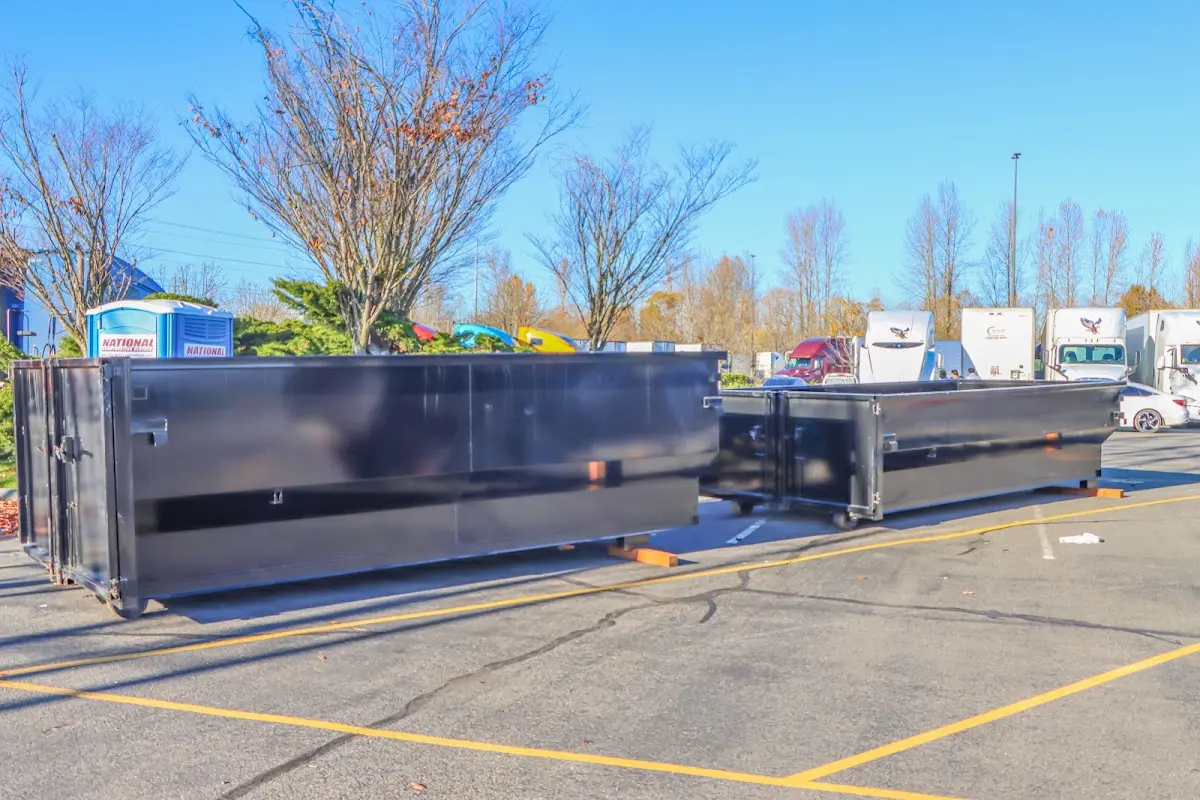 Professional dumpster rental service with roll-off container on residential driveway in Aransas Pass